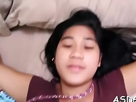 Asian wench enjoys attracting a ride on cock after sucking tingle